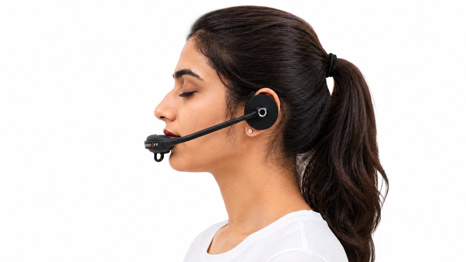 A woman wearing the MindOFF™ device, shown in side profile