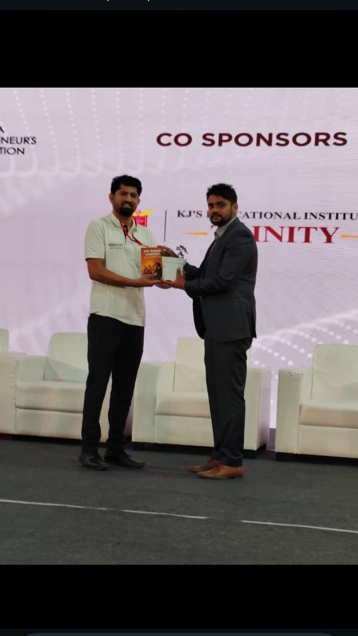 Mr. Vijay Thakre receiving a co-sponsor award on stage